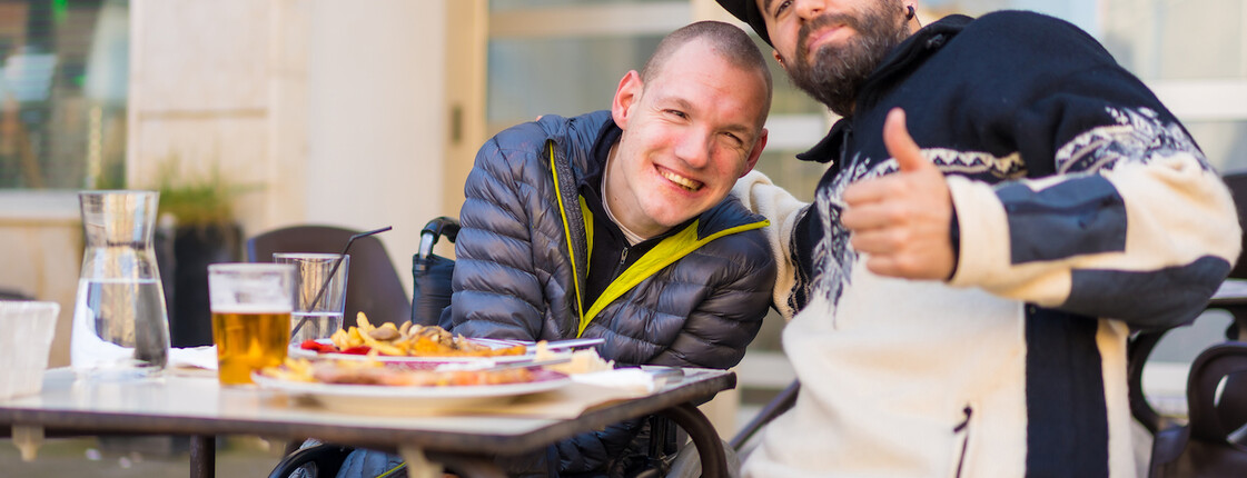 Selfie and portrait of friends eating in a restaurant terrace, disabled person eating Selfie and portrait of friends eating in a restaurant terrace, disabled person eating